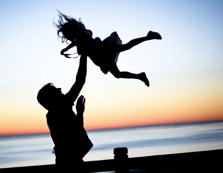 Silhouette of an adult lifting a child at sunset, symbolizing de facto custodian and non-parent custody in Kentucky &mdash; how grandparents, stepparents, and relatives can seek custody under KRS 403.270